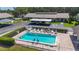 Aerial view of community pool with lounge chairs and shaded parking area at 6012 28Th W St, Bradenton, FL 34207