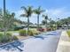 View down neighborhood street with palm trees, landscaping, and American flag at 6012 28Th W St, Bradenton, FL 34207