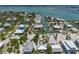 Aerial view of the neighborhood, showcasing the homes, canal, and gulf access at 9712 Little Gasparilla Is, Boca Grande, FL 33921