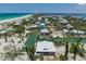 Aerial view of the waterfront home and surrounding community, showcasing the canal and gulf access at 9712 Little Gasparilla Is, Boca Grande, FL 33921