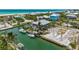 Aerial view of the home and waterfront, showcasing boat dock, boat lift, and gulf access at 9712 Little Gasparilla Is, Boca Grande, FL 33921