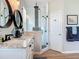 Contemporary bathroom showcasing a double vanity and a glass-enclosed shower at 9712 Little Gasparilla Is, Boca Grande, FL 33921