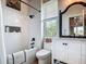 Well-lit bathroom features a shower and tub, dark fixtures, and white cabinets and countertop at 9712 Little Gasparilla Is, Boca Grande, FL 33921