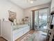 Cozy bedroom with stylish decor and sliding glass doors to outdoor patio at 9712 Little Gasparilla Is, Boca Grande, FL 33921