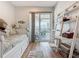 Well-lit bedroom featuring a daybed, shelving unit, and sliding glass doors at 9712 Little Gasparilla Is, Boca Grande, FL 33921
