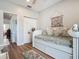 Charming bedroom with a daybed, nautical decor, and wood-look flooring at 9712 Little Gasparilla Is, Boca Grande, FL 33921