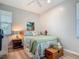 Cozy bedroom boasts a bed, chest, end table, painting, and bright, natural light at 9712 Little Gasparilla Is, Boca Grande, FL 33921