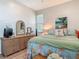 Bedroom featuring a bed, dresser, mirror, painting, and bright, natural light at 9712 Little Gasparilla Is, Boca Grande, FL 33921