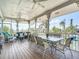 Covered porch features outdoor dining and living spaces with canal views at 9712 Little Gasparilla Is, Boca Grande, FL 33921