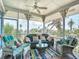 Cozy screened-in porch offers comfortable seating and views of the lush surroundings at 9712 Little Gasparilla Is, Boca Grande, FL 33921