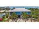 Coastal home with a metal roof and screened porch is elevated over tropical landscaping at 9712 Little Gasparilla Is, Boca Grande, FL 33921