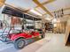 Organized garage featuring a golf cart and ample tool storage at 9712 Little Gasparilla Is, Boca Grande, FL 33921