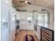 Spacious kitchen with stainless appliances, white cabinets, large island and wood plank ceiling at 9712 Little Gasparilla Is, Boca Grande, FL 33921