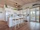 Kitchen with breakfast bar, white cabinets, wood plank ceiling, and decor at 9712 Little Gasparilla Is, Boca Grande, FL 33921