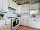 Updated kitchen with white cabinetry, granite countertops, stainless appliances, and modern fixtures at 9712 Little Gasparilla Is, Boca Grande, FL 33921