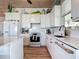 Bright kitchen featuring white cabinets, stainless steel appliances, and modern finishes at 9712 Little Gasparilla Is, Boca Grande, FL 33921