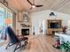 View of the living room featuring fireplace, ceiling fan, wood floors, and view of a TV at 9712 Little Gasparilla Is, Boca Grande, FL 33921