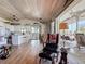 Open concept living room and kitchen featuring wood floors, ceiling fan, and view of the porch at 9712 Little Gasparilla Is, Boca Grande, FL 33921