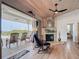 Living room featuring fireplace, ceiling fan, wood floors, and sliding doors to the outdoor porch at 9712 Little Gasparilla Is, Boca Grande, FL 33921