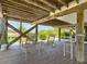 View of the outdoor seating area, showing chairs, barstools, and the water in the distance at 9712 Little Gasparilla Is, Boca Grande, FL 33921