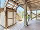 View of the underside of the house, showing the pilings, stairs, elevator, and outdoor shower at 9712 Little Gasparilla Is, Boca Grande, FL 33921