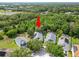Aerial view of a home surrounded by mature trees and a well-maintained yard at 16804 Hawkridge Rd, Lithia, FL 33547