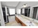 Well-designed bathroom with dual sinks, a soaking tub, and a separate tiled shower with a glass block window at 16804 Hawkridge Rd, Lithia, FL 33547