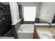 Beautiful bathroom with a relaxing soaking tub and separate tiled shower, both featuring glass block windows at 16804 Hawkridge Rd, Lithia, FL 33547