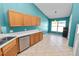 Dining area features a window, tile flooring, and modern appliances at 16804 Hawkridge Rd, Lithia, FL 33547