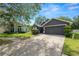 Charming home with a well-maintained lawn, driveway, and two-car garage at 16804 Hawkridge Rd, Lithia, FL 33547