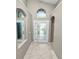 Bright foyer with tile flooring, arched windows, and neutral paint tones welcomes you into this lovely home at 16804 Hawkridge Rd, Lithia, FL 33547