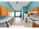 Open kitchen featuring oak cabinets, stainless steel appliances, and ample counter space at 16804 Hawkridge Rd, Lithia, FL 33547