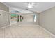 Bright living room with neutral walls, tile flooring, and a smooth transition to the kitchen area at 16804 Hawkridge Rd, Lithia, FL 33547