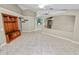 Spacious living room with a custom built-in, smooth tile floors, and a cohesive design aesthetic at 16804 Hawkridge Rd, Lithia, FL 33547