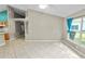 Open-concept living room showcases tile flooring and abundant natural light, creating a bright and airy ambiance at 16804 Hawkridge Rd, Lithia, FL 33547