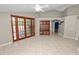 Comfortable living room featuring neutral paint, tile flooring, and wooden french doors leading to outdoor space at 16804 Hawkridge Rd, Lithia, FL 33547