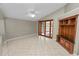 Bright living room with tiled floors and vaulted ceilings showcasing the decorative, built-in shelving unit at 16804 Hawkridge Rd, Lithia, FL 33547