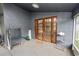 Covered outdoor patio featuring double doors and access to the backyard at 16804 Hawkridge Rd, Lithia, FL 33547