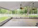 Relaxing screened-in patio with ceiling fans overlooks the peaceful backyard at 16804 Hawkridge Rd, Lithia, FL 33547