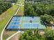Overhead shot showing outdoor tennis courts with lush surroundings and a walking path, offering recreation at 16804 Hawkridge Rd, Lithia, FL 33547