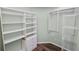 Organized walk-in closet with ample shelving, drawers, and hanging space for clothing and storage at 16804 Hawkridge Rd, Lithia, FL 33547