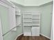 Spacious walk-in closet with built-in shelving and drawers offers ample storage and organization at 16804 Hawkridge Rd, Lithia, FL 33547