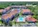 Condominium community with a pool, manicured green space, and mature landscaping creating a serene environment at 18001 Richmond Place Dr # 337, Tampa, FL 33647