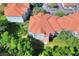 Aerial view of multi-story building with red roof and nearby trees. Arrow points to the building at 18001 Richmond Place Dr # 337, Tampa, FL 33647