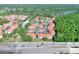Aerial view of community with multiple buildings and red roofs, highlighting location near highway and lake at 18001 Richmond Place Dr # 337, Tampa, FL 33647