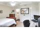 Bright bedroom featuring a ceiling fan, neutral walls, and doorway to an attached bathroom and study area at 18001 Richmond Place Dr # 337, Tampa, FL 33647