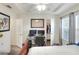 Well-lit bedroom with a ceiling fan and a workspace with dual monitors and closet access at 18001 Richmond Place Dr # 337, Tampa, FL 33647
