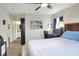 Cozy bedroom with neutral colors, a ceiling fan, and a doorway to an en-suite bathroom at 18001 Richmond Place Dr # 337, Tampa, FL 33647