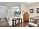 Bright dining area with seating and a view of the kitchen and the front door at 18001 Richmond Place Dr # 337, Tampa, FL 33647