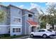The exterior of the condo building has gray siding with a white trim and a red tiled roof at 18001 Richmond Place Dr # 337, Tampa, FL 33647